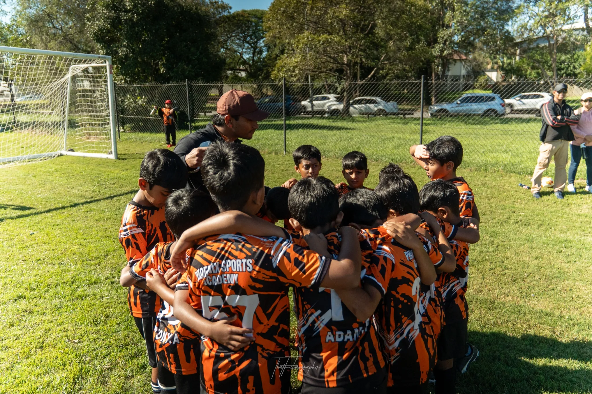 Phoenix Sports Academy youth soccer team huddle