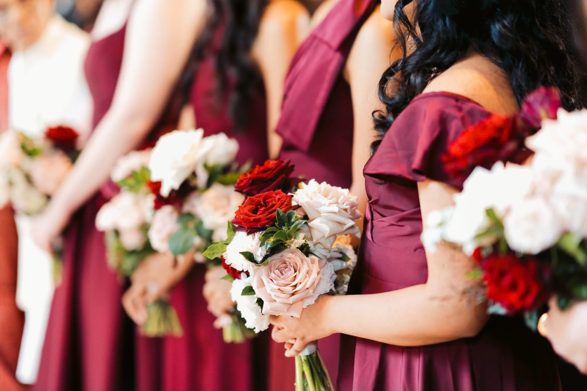 Wedding bridesmaids holding floral bouquets